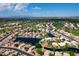 Expansive aerial view showcasing a large community with lakes and green spaces at 20740 N 62Nd Ave, Glendale, AZ 85308