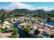 Aerial view showcasing a beautiful neighborhood with lakes, lush landscaping, and mountain views at 20740 N 62Nd Ave, Glendale, AZ 85308