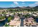 Beautiful aerial view of a golf course community with lake and mountain views at 20740 N 62Nd Ave, Glendale, AZ 85308