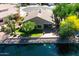 Aerial view of a home with lush backyard, lake view, and desert landscaping at 20740 N 62Nd Ave, Glendale, AZ 85308