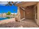 Inviting covered back patio with brick pavers, ceiling fan and easy access to the beautifully landscaped backyard at 20740 N 62Nd Ave, Glendale, AZ 85308