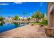 Stunning backyard view with lush landscaping, water feature, brick pavers, and waterfront homes across the canal at 20740 N 62Nd Ave, Glendale, AZ 85308