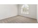Bright bedroom features a large window with shutters and neutral carpeting at 20740 N 62Nd Ave, Glendale, AZ 85308