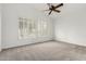 Bedroom with carpeted floor, ceiling fan, and bright windows with shutter style shades at 20740 N 62Nd Ave, Glendale, AZ 85308