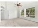 Spacious bedroom featuring carpeted floors, a ceiling fan, and a beautiful view of the lake at 20740 N 62Nd Ave, Glendale, AZ 85308