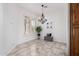 Light and airy dining room with tiled flooring, plantation shutters, and decorative chandelier at 20740 N 62Nd Ave, Glendale, AZ 85308
