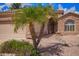 Charming single-Gathering home with desert landscaping, stone accents, and an arched entryway at 20740 N 62Nd Ave, Glendale, AZ 85308