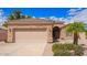 Attractive house with a two-car garage, desert landscaping, and a stone facade at 20740 N 62Nd Ave, Glendale, AZ 85308