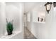Inviting hallway with archways, plant nook, and tile flooring at 20740 N 62Nd Ave, Glendale, AZ 85308