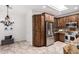 Open kitchen featuring stainless steel appliances, granite countertops, and tile flooring at 20740 N 62Nd Ave, Glendale, AZ 85308
