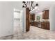 Well-equipped kitchen showcasing modern appliances, cabinetry, and tile flooring with adjacent laundry room at 20740 N 62Nd Ave, Glendale, AZ 85308