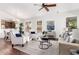 Bright living room featuring hardwood floors, a ceiling fan, and multiple windows at 20740 N 62Nd Ave, Glendale, AZ 85308
