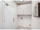 Mud room with overhead cabinets and tiled floors provides functionality and storage at 20740 N 62Nd Ave, Glendale, AZ 85308