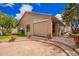 Charming home's rear exterior featuring a brick patio, well-manicured lawn, and mature trees for privacy at 20740 N 62Nd Ave, Glendale, AZ 85308