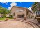Charming home's rear exterior featuring a brick patio, well-manicured lawn, and mature trees for privacy at 20740 N 62Nd Ave, Glendale, AZ 85308