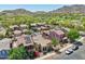 Aerial view of homes with tile roofs, lush landscaping, and solar panels, set against a stunning mountain backdrop at 21155 W Green St, Buckeye, AZ 85396