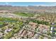 Aerial view showcases a community surrounded by a golf course with mountain views in the distance at 21155 W Green St, Buckeye, AZ 85396