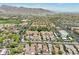 Aerial view showcases a community surrounded by a golf course with mountain views in the distance at 21155 W Green St, Buckeye, AZ 85396