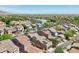 Scenic aerial view of houses in a well-planned neighborhood, featuring solar panels and lush landscaping under a clear sky at 21155 W Green St, Buckeye, AZ 85396