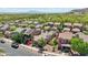 This is an aerial view of homes with beautiful desert landscaping and solar panels nestled near desert mountains at 21155 W Green St, Buckeye, AZ 85396