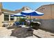 Cozy backyard with blue patio furniture, string lights, and a built-in barbecue for outdoor entertaining at 21155 W Green St, Buckeye, AZ 85396