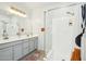 Bright bathroom featuring a glass shower, neutral vanity with double sinks, and modern fixtures at 21155 W Green St, Buckeye, AZ 85396