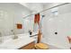 Neutral-toned bathroom featuring a shower-tub combo with a window, a vanity, and an orange hand towel at 21155 W Green St, Buckeye, AZ 85396