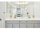 Bright bathroom with double sinks, a large mirror, and modern lighting fixtures at 21155 W Green St, Buckeye, AZ 85396