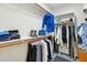 Walk-in closet with wooden rods, shelving, and ample storage space for clothing and accessories at 21155 W Green St, Buckeye, AZ 85396