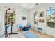 Brightly lit exercise room featuring a pull up bar, weight bench, yoga mat, and natural light through the windows at 21155 W Green St, Buckeye, AZ 85396