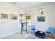 Exercise room featuring a pull-up bar, two chairs, a blue ottoman, and many framed prints at 21155 W Green St, Buckeye, AZ 85396