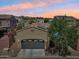 Beautiful home with a gray garage door, desert landscaping, and solar panels nestled in a scenic mountain community at 21155 W Green St, Buckeye, AZ 85396