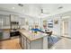 Bright kitchen featuring a granite island, stainless steel appliances, and an eat-in dining space at 21155 W Green St, Buckeye, AZ 85396