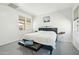 Clean main bedroom with a king-sized bed, bench at the foot of the bed, and lots of natural light at 21155 W Green St, Buckeye, AZ 85396