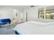 Main bedroom featuring a king-sized bed with white covers, a rug, and an arched entry to the en-suite bathroom at 21155 W Green St, Buckeye, AZ 85396