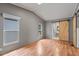 Bright bedroom with hardwood floors, barn door, and natural light from the windows at 2121 N Center St # 166, Mesa, AZ 85201