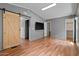 Spacious bedroom with vaulted ceiling, hardwood floors, and a barn door at 2121 N Center St # 166, Mesa, AZ 85201