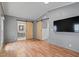 Contemporary bedroom featuring barn doors, gray walls, and wood-look floors at 2121 N Center St # 166, Mesa, AZ 85201