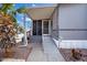 Home entrance featuring a covered porch, ramp access, and welcoming landscaping at 2121 N Center St # 166, Mesa, AZ 85201