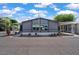 Charming home exterior with well-maintained landscaping and a covered parking area at 2121 N Center St # 166, Mesa, AZ 85201
