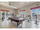 Stay active in the game room featuring exercise equipment, a pool table, and plenty of natural light at 2121 N Center St # 166, Mesa, AZ 85201