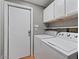 Bright laundry room with washer and dryer, featuring white cabinets for storage at 2121 N Center St # 166, Mesa, AZ 85201