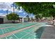 Enjoy outdoor recreation on the well-maintained shuffleboard courts, surrounded by mature trees and lush landscaping at 2121 N Center St # 166, Mesa, AZ 85201