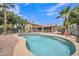 Relaxing backyard oasis with a sparkling blue pool, lush landscaping, and plenty of space for entertaining at 2343 E Kempton Rd, Chandler, AZ 85225