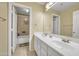 Bright bathroom with double sinks, white cabinetry, and separate shower and bathtub at 2343 E Kempton Rd, Chandler, AZ 85225