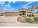 Charming single-story home with a three-car garage, arched entryway, and manicured desert landscaping at 2343 E Kempton Rd, Chandler, AZ 85225