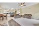 Open concept living room showcasing dual sofas, a ceiling fan, and seamless flow to the kitchen at 2343 E Kempton Rd, Chandler, AZ 85225