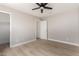 An airy bedroom with light wood flooring and a ceiling fan at 2502 N 22Nd Dr, Phoenix, AZ 85009