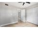 A bedroom featuring light wood flooring, fan and an ensuite bathroom at 2502 N 22Nd Dr, Phoenix, AZ 85009