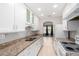 Modern kitchen with stainless sink, granite counters, archway, and modern appliances at 2502 N 22Nd Dr, Phoenix, AZ 85009